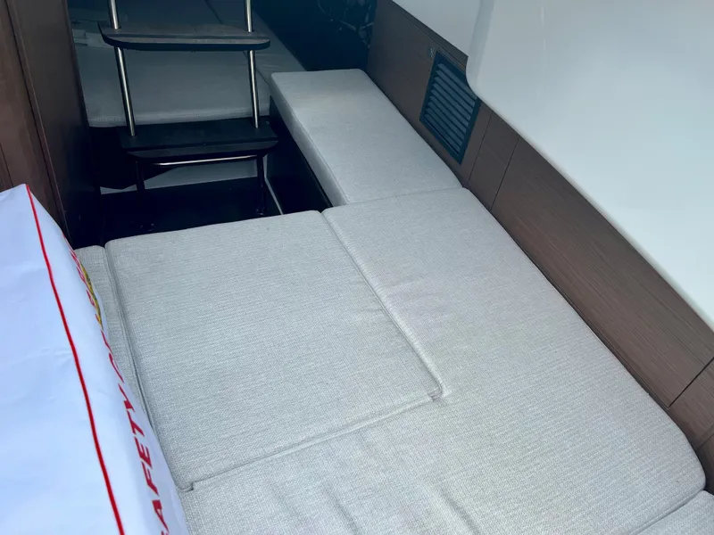 Slide: The Image of 2024 Jeanneau Leader 9.0 CC cabin interior with cushioned seating and steps. - 20