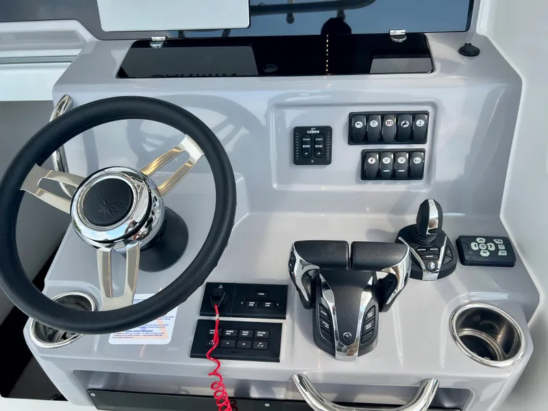 Slide: The Image of 2024 Jeanneau Leader 9.0 CC helm station with steering wheel and control panel. - 7
