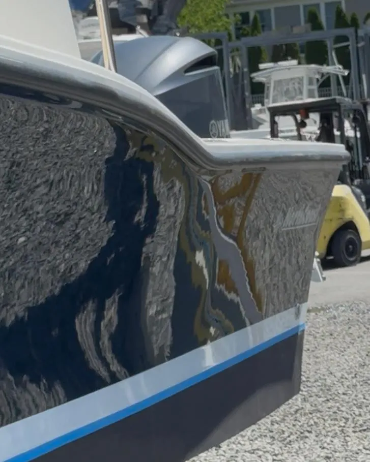 Slide: The Image of 2022 NorthCoast 235 HT boat with sleek design and reflective hull. - 2