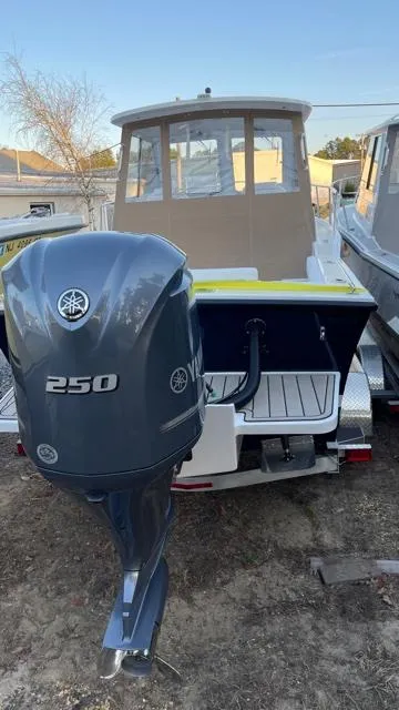 Slide: The Image of 2022 NorthCoast 235 HT boat with Yamaha 250 outboard motor, docked outdoors. - 20