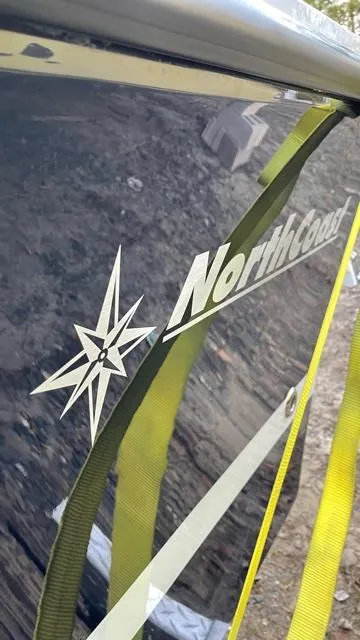Slide: The Image of 2022 NorthCoast 235 HT boat with logo and compass design on the side. - 21