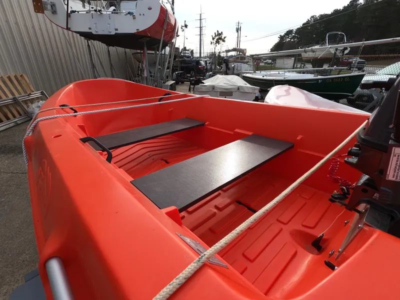 Slide: The Image of Orange River Boats 290, 2022 model, docked with visible seating and ropes. - 3