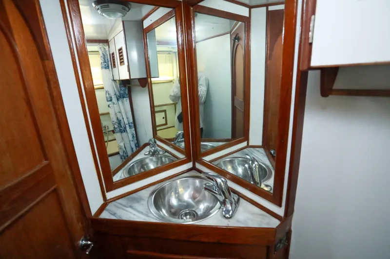Slide: The Image of 1979 Sea Ranger 37 yacht bathroom with wooden cabinetry and stainless steel sink. - 24