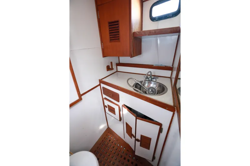 Slide: The Image of 1979 Sea Ranger 37 yacht bathroom with wooden cabinetry and stainless steel sink. - 29