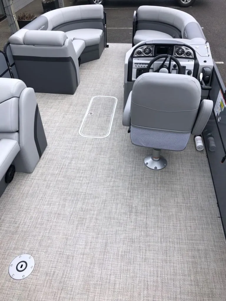 Slide: The Image of 2023 South Bay S224CR2 2.75 pontoon boat interior with grey seating and steering console. - 10