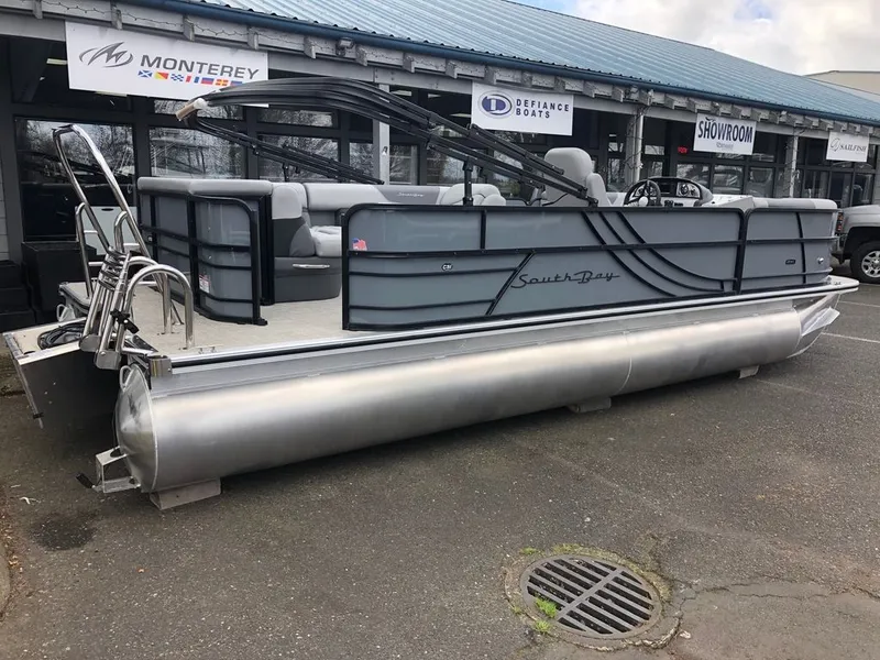 Slide: The Image of 2023 South Bay S224CR2 2.75 pontoon boat displayed outside a showroom. - 15
