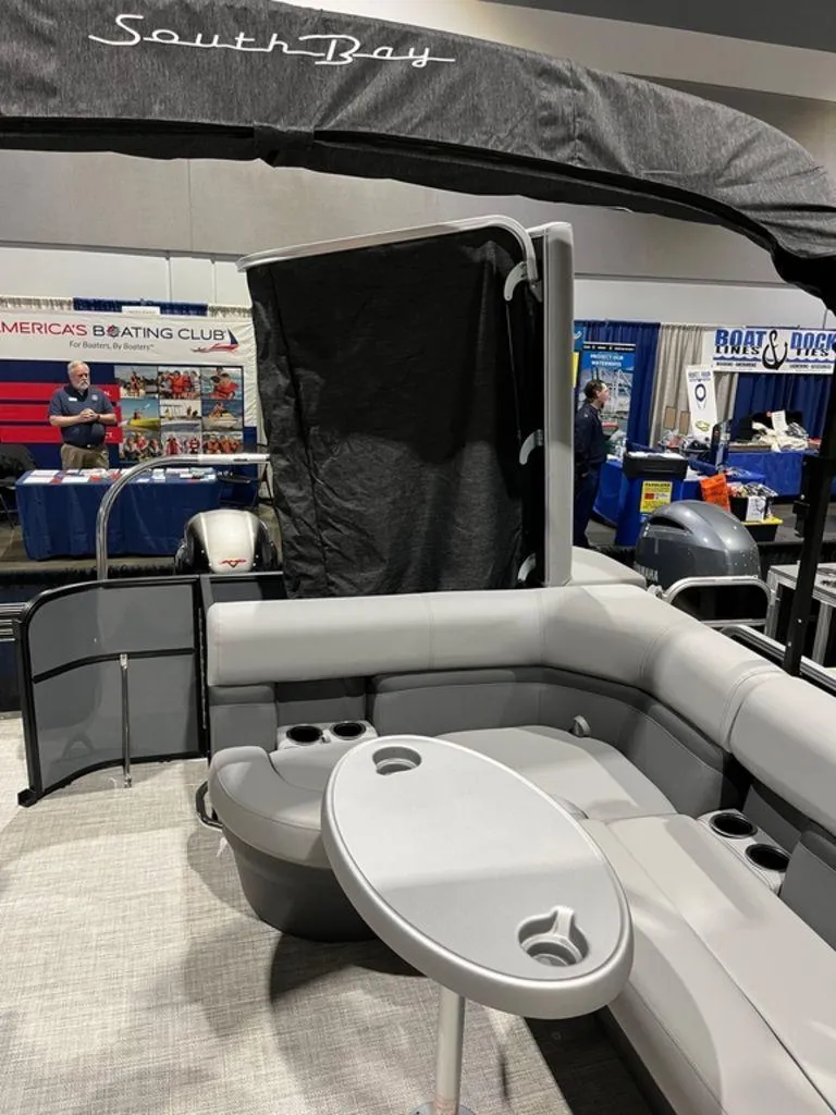 Slide: The Image of 2023 South Bay S224CR2 2.75 pontoon boat interior at a boating expo. - 6