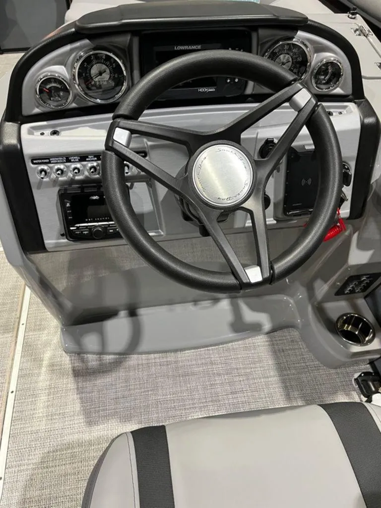 Slide: The Image of 2023 South Bay S224CR2 2.75 boat dashboard with steering wheel and control panel. - 7