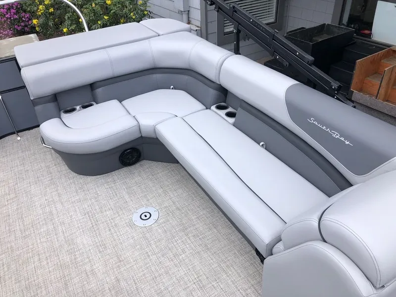Slide: The Image of Interior of 2022 South Bay S224CR pontoon boat with gray seating. - 13