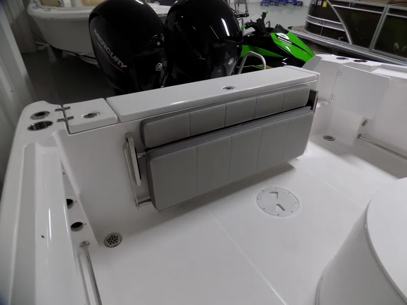 Slide: The Image of 2022 Aquasport 2500 boat interior with foldable seating and dual outboard motors. - 4