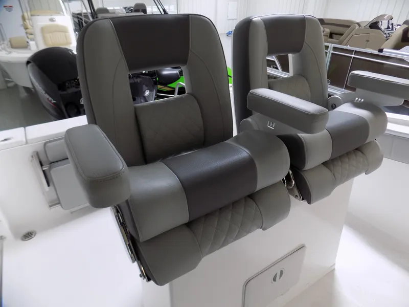 Slide: The Image of 2022 Aquasport 2500 boat seats, featuring gray and black cushioned design with armrests. - 5