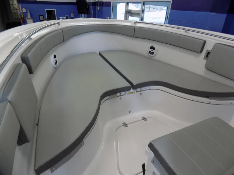 Slide: The Image of 2022 Aquasport 2500 boat interior with gray cushioned seating and modern design. - 9