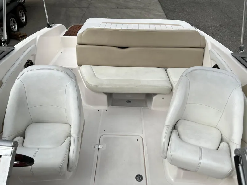 Slide: The Image of 2013 Regal 1900 boat interior with white seating and beige backrest. - 11