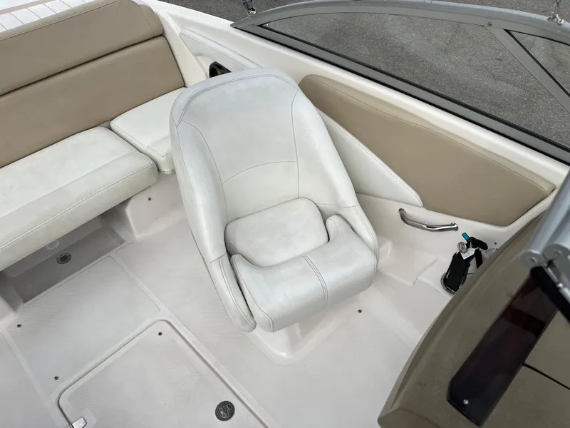 Slide: The Image of 2013 Regal 1900 boat interior with white and beige seating. - 13