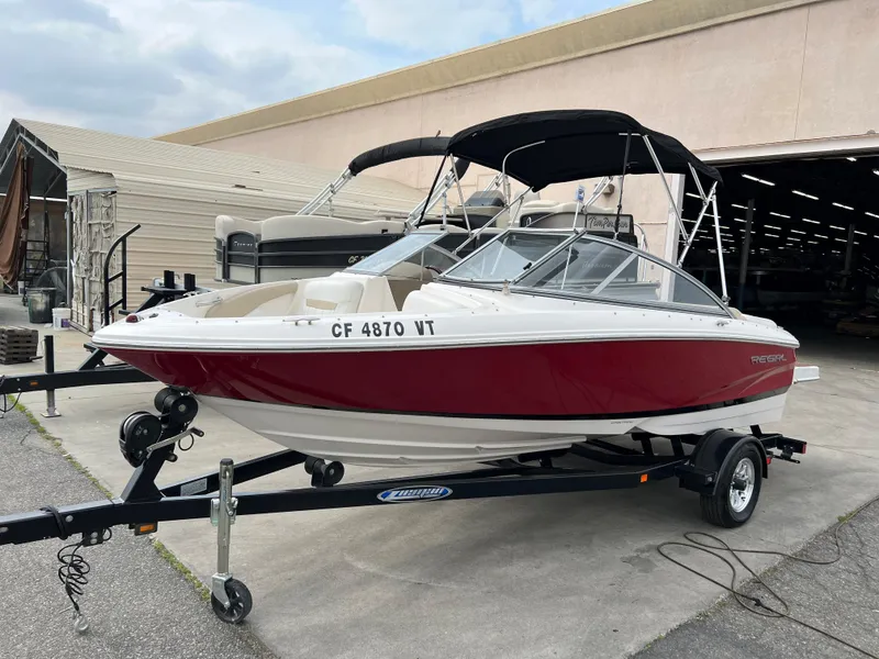 Slide: The Image of 2013 Regal 1900 boat on trailer with red and white exterior. - 3
