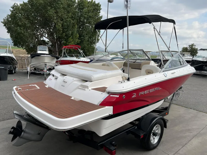 Slide: The Image of 2013 Regal 1900 boat with red and white exterior on a trailer. - 5