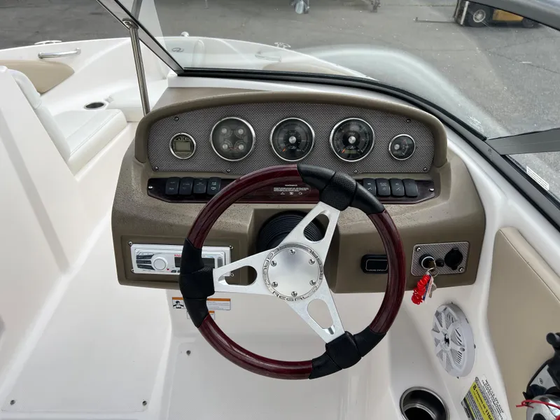 Slide: The Image of 2013 Regal 1900 boat dashboard with steering wheel and instrument panel. - 9