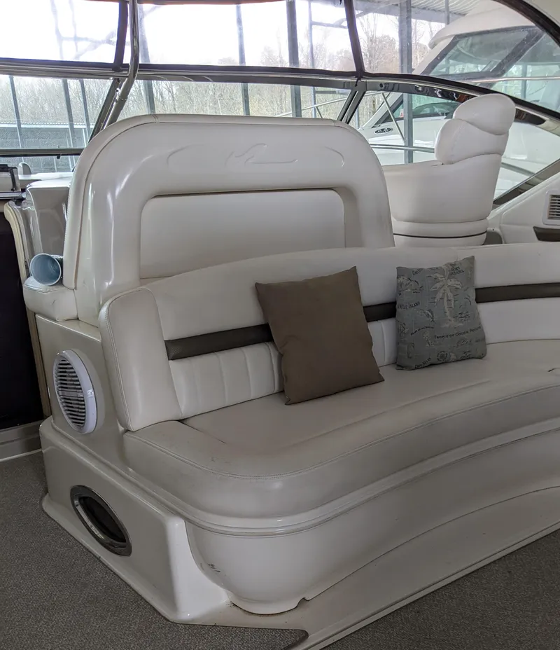 Slide: The Image of 2006 Sea Ray 44 Sundancer yacht interior with white leather seating and decorative pillows. - 11