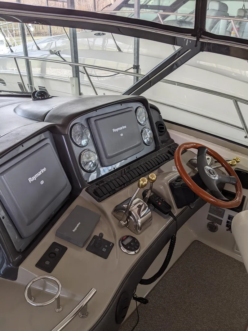 Slide: The Image of Helm of 2006 Sea Ray 44 Sundancer with Raymarine electronics and wooden steering wheel. - 13