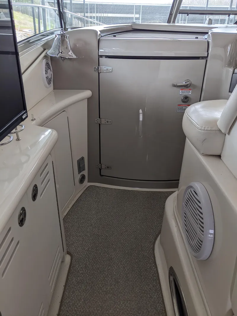 Slide: The Image of Interior of a 2006 Sea Ray 44 Sundancer yacht with beige cabinetry and seating. - 16