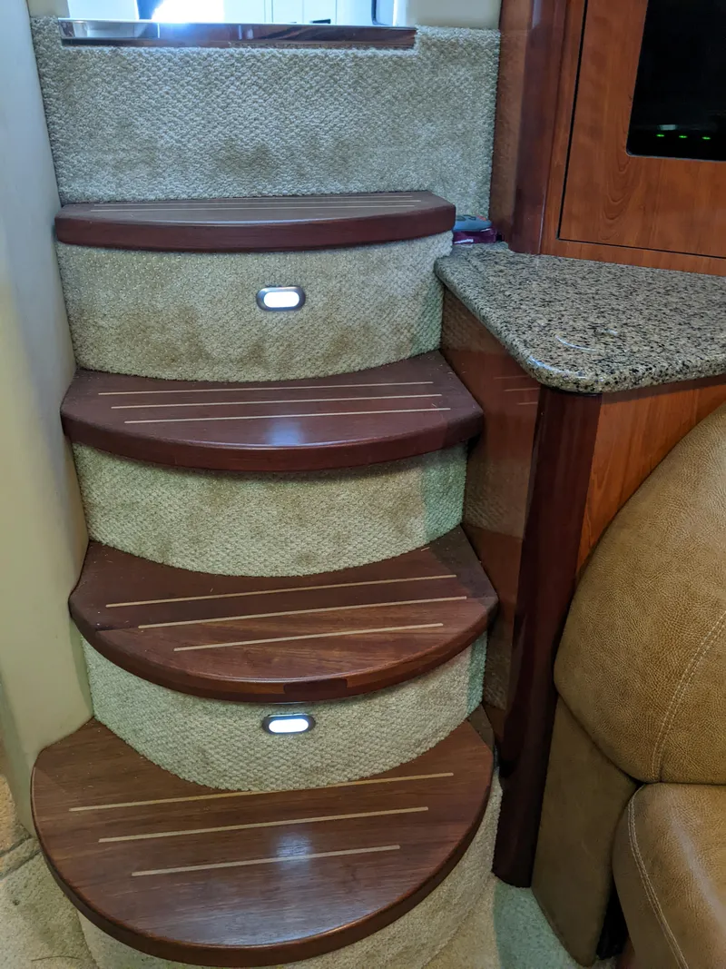 Slide: The Image of 2006 Sea Ray 44 Sundancer interior steps with wood and carpet finish - 18