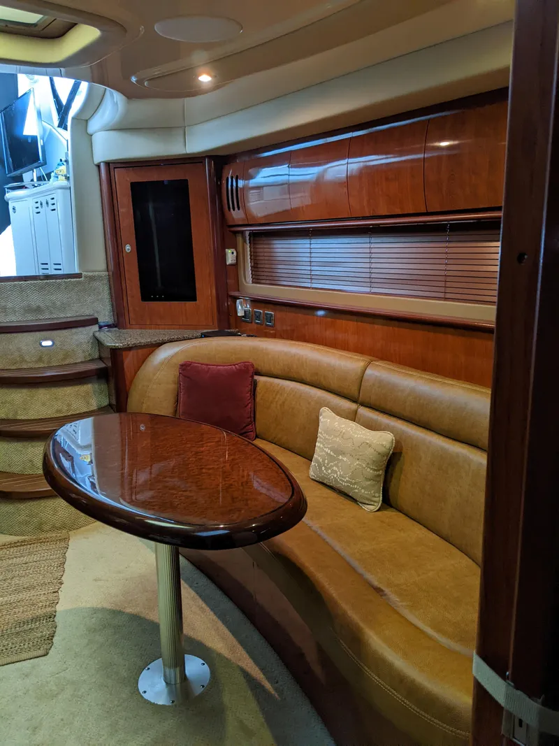 Slide: The Image of Interior of 2006 Sea Ray 44 Sundancer yacht with leather seating and wooden table. - 19