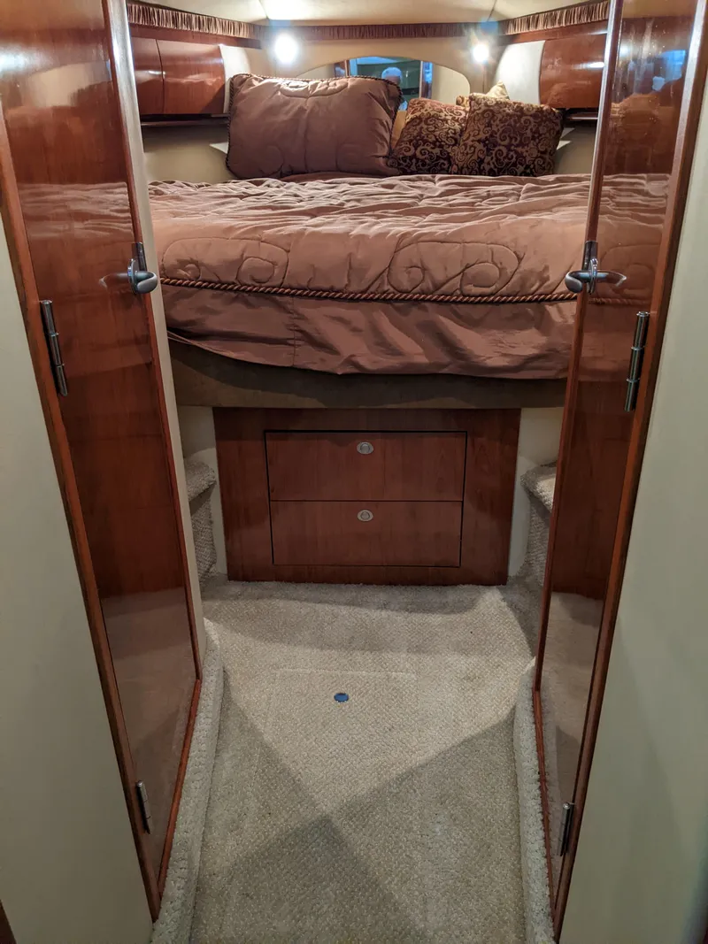 Slide: The Image of Luxurious bedroom interior of 2006 Sea Ray 44 Sundancer yacht with wooden cabinetry. - 25