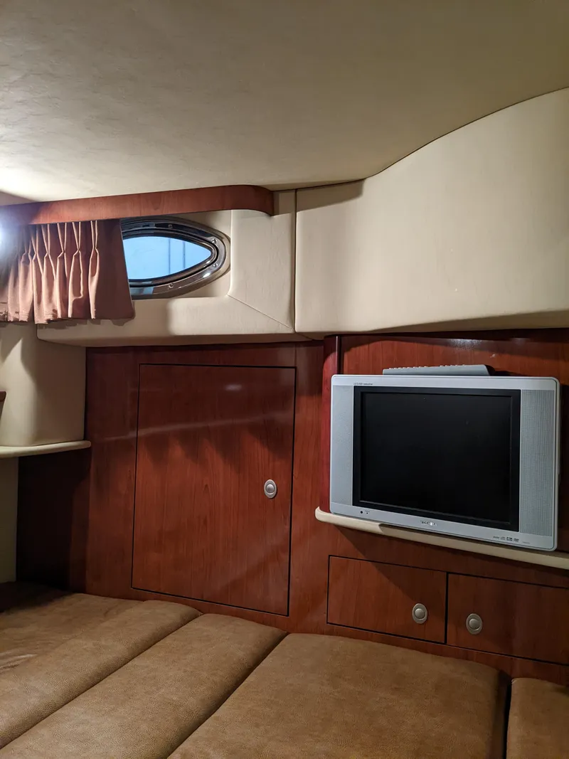 Slide: The Image of Interior cabin of 2006 Sea Ray 44 Sundancer with TV and porthole window. - 29