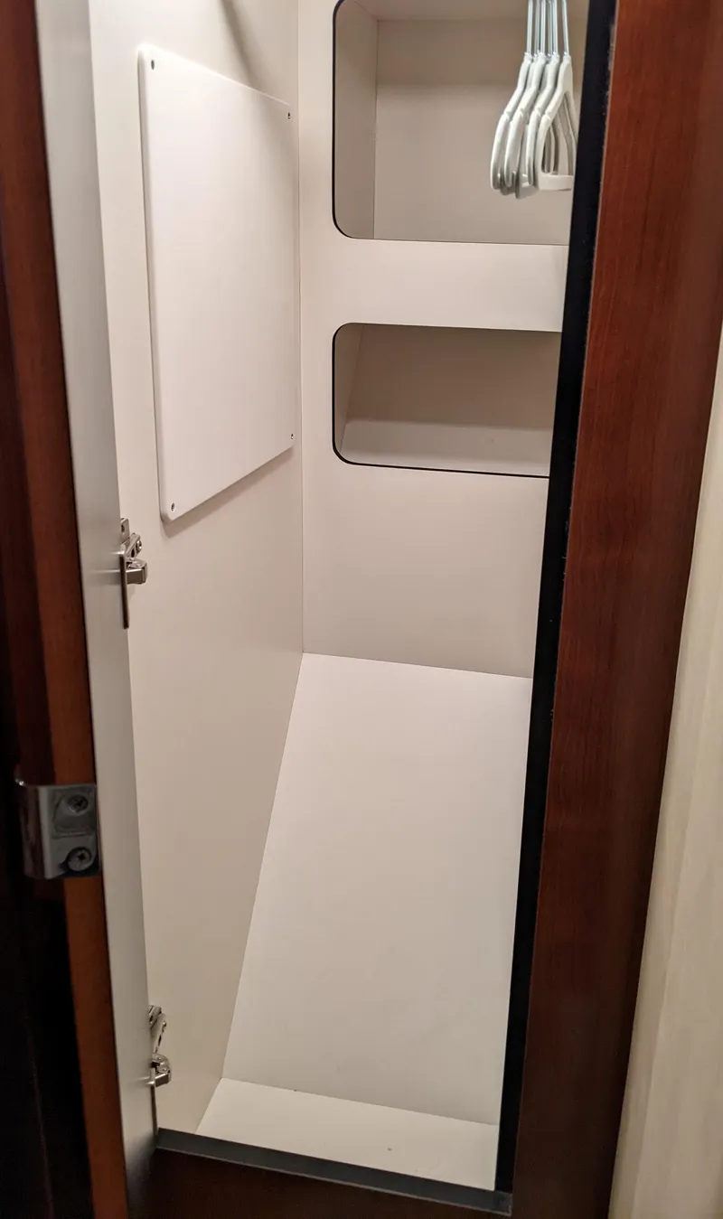Slide: The Image of 2006 Sea Ray 44 Sundancer closet with shelves and hangers - 34