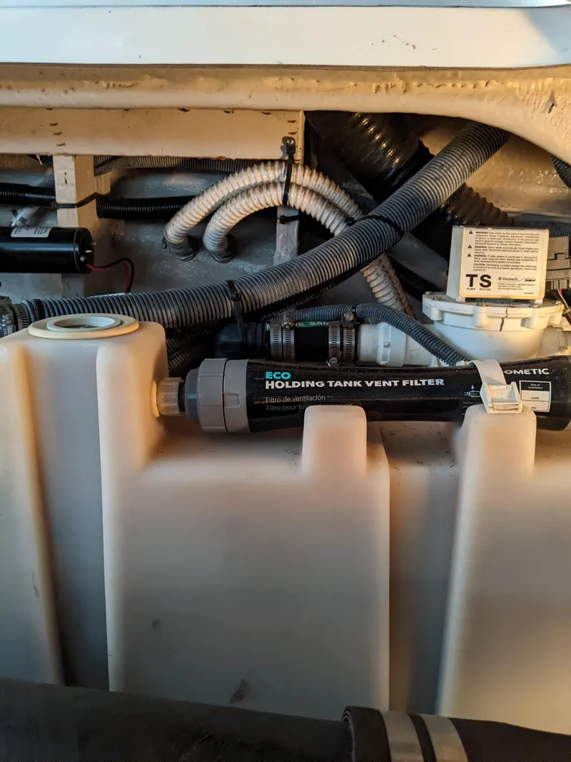 Slide: The Image of 2006 Sea Ray 44 Sundancer holding tank vent filter and wiring. - 43