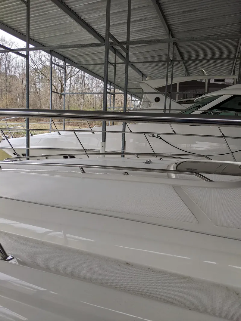 Slide: The Image of 2006 Sea Ray 44 Sundancer yacht docked under a covered marina. - 44