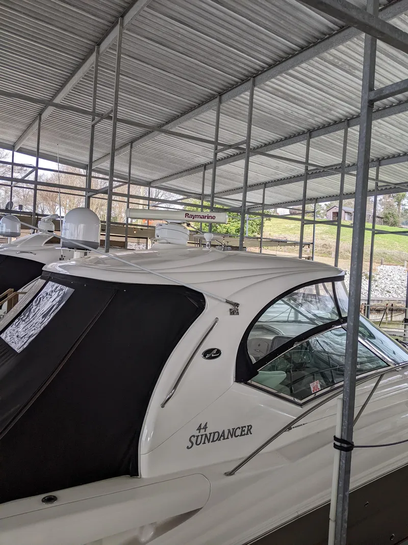 Slide: The Image of 2006 Sea Ray 44 Sundancer yacht docked under a covered marina. - 46