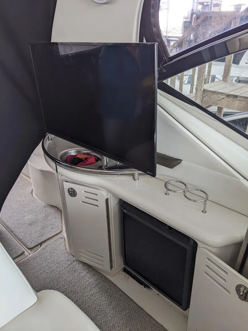 Slide: The Image of Flat-screen TV and storage area inside a 2006 Sea Ray 44 Sundancer yacht. - 6
