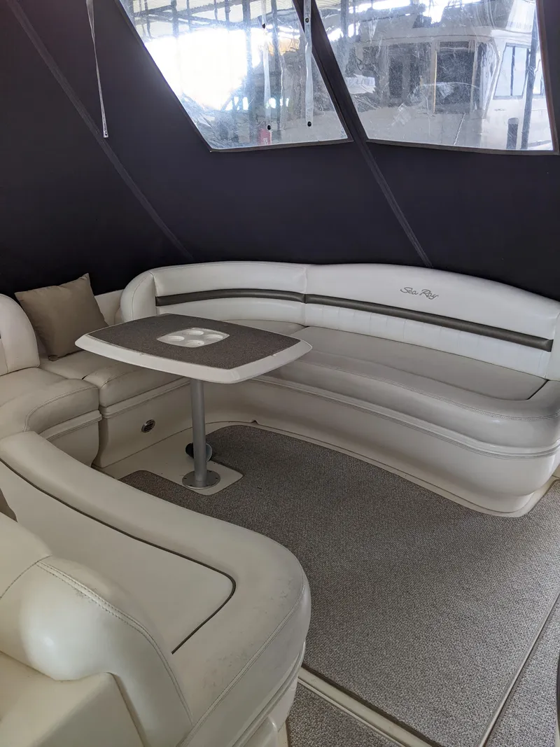 Slide: The Image of 2006 Sea Ray 44 Sundancer interior with white leather seating and table. - 8
