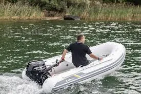 Slide: The Image of 2022 ZAR Mini Rib 10 Lite inflatable boat on water with person steering. - 9