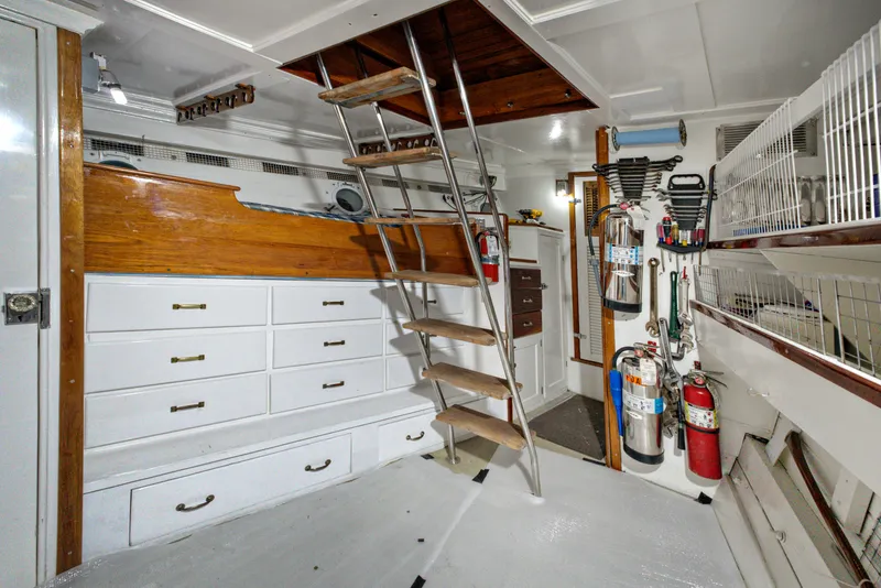 Slide: The Image of Interior of 1929 HOFFAR-BEECHING Fantail Yacht with wooden stairs and storage drawers. - 29