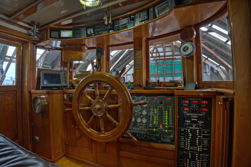 Slide: The Image of 1929 HOFFAR-BEECHING Fantail Yacht helm with wooden wheel and modern navigation equipment. - 37