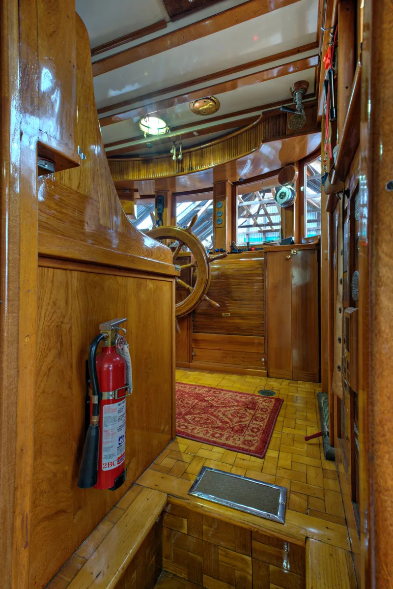Slide: The Image of 1929 Custom HOFFAR-BEECHING Fantail Yacht interior with wooden helm and fire extinguisher. - 41