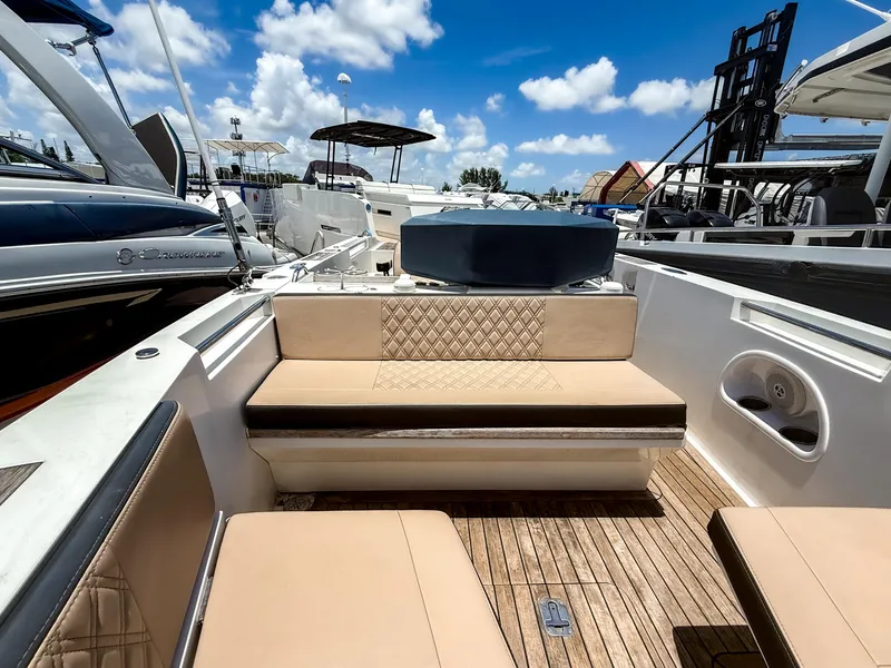 Slide: The Image of 2011 Novurania Chase 23 boat interior with beige seating and wooden deck. - 12