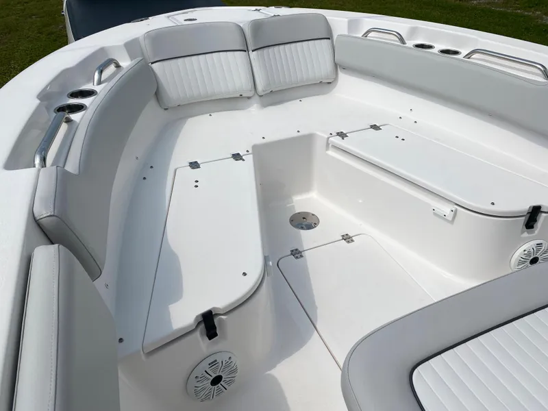 Slide: The Image of 2020 Sea Fox Commander 248 boat interior with white cushioned seating and storage compartments. - 15