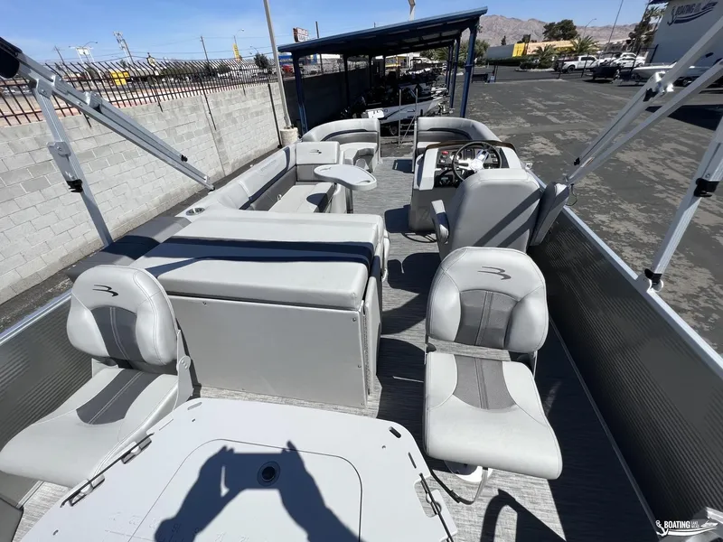 Slide: The Image of 2022 Bennington 21 SXRF pontoon boat interior with gray seating and steering console. - 9