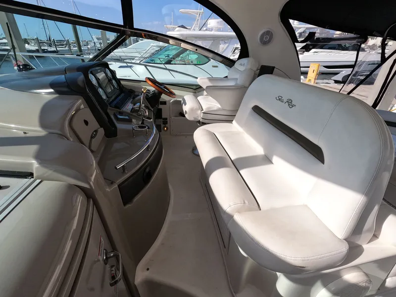 Slide: The Image of Interior of 2007 Sea Ray 44 Sundancer yacht with white seating and modern helm. - 25