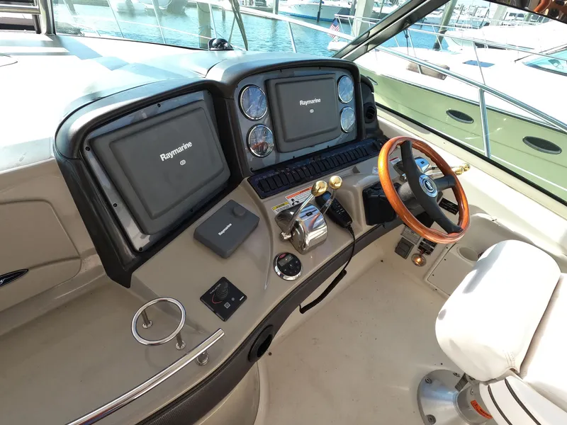 Slide: The Image of Helm of 2007 Sea Ray 44 Sundancer with Raymarine electronics and wooden steering wheel. - 26