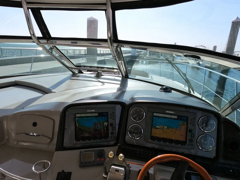 Slide: The Image of Helm of 2007 Sea Ray 44 Sundancer with navigation screens and gauges. - 28