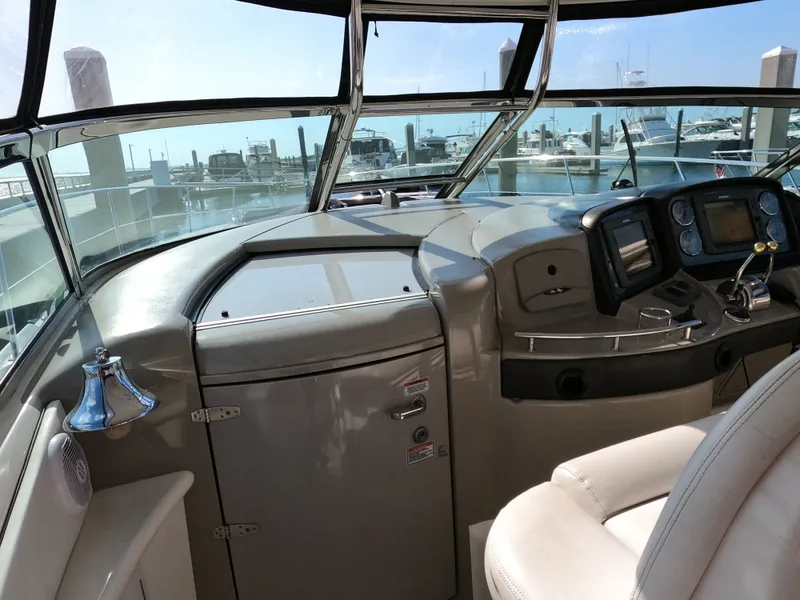 Slide: The Image of Helm of 2007 Sea Ray 44 Sundancer yacht with navigation instruments and marina view. - 30