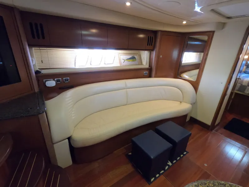 Slide: The Image of Interior of 2007 Sea Ray 44 Sundancer with cream leather sofa and wooden cabinetry. - 34