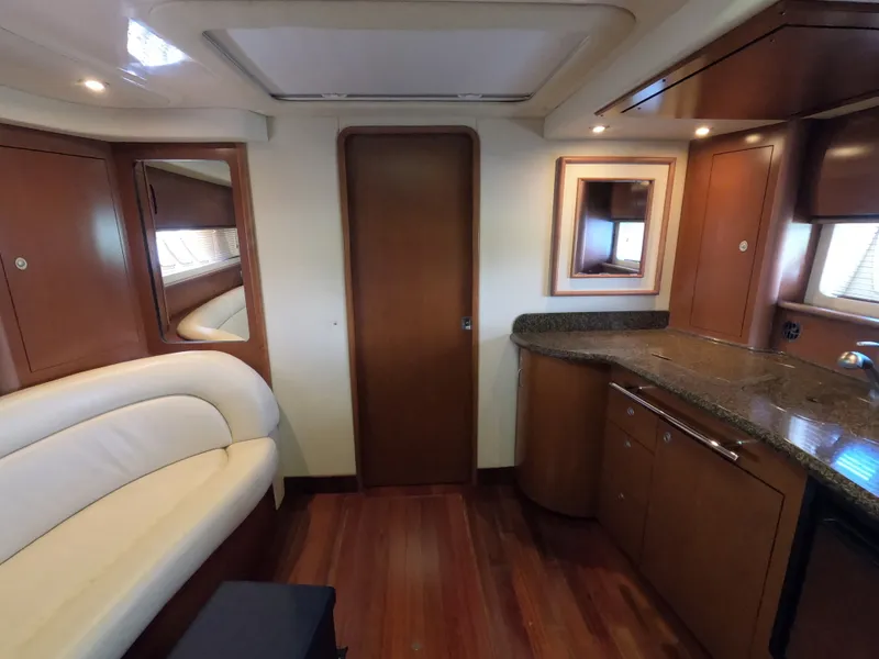 Slide: The Image of Interior of 2007 Sea Ray 44 Sundancer yacht with wood cabinetry and white leather seating. - 42