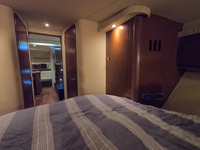 Slide: The Image of Interior cabin of 2007 Sea Ray 44 Sundancer yacht with bed and wooden furnishings. - 46