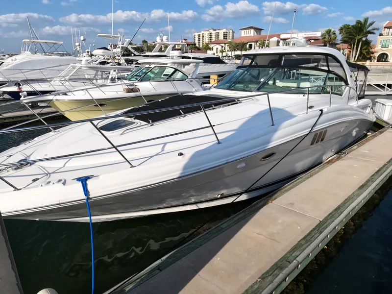Slide: The Image of 2007 Sea Ray 44 Sundancer yacht docked at a marina on a sunny day. - 6