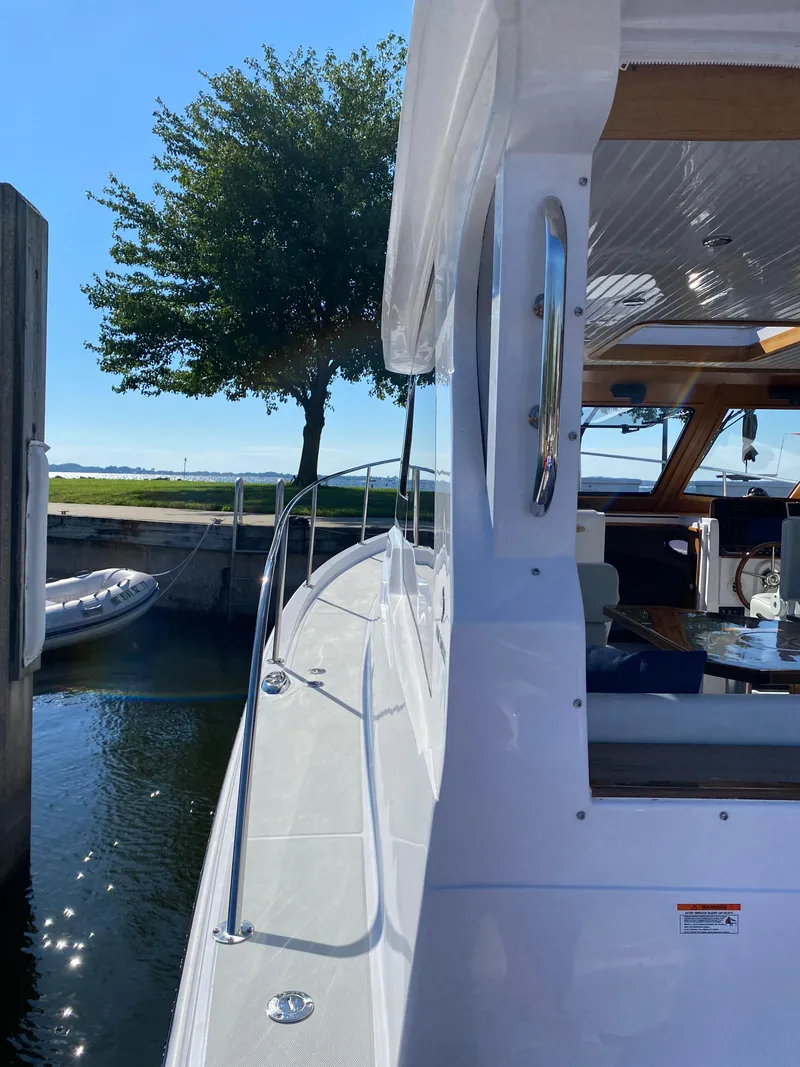 Slide: The Image of 2023 True North 34 Outboard Express docked, showcasing sleek design and spacious deck. - 14